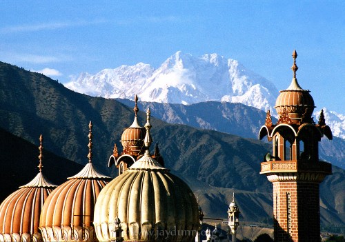 Pakistan, Northwest Frontier Province, 2004. Tirich Mir, at 7,705 meters, rises high above Chitrals valley location in the NWFP. Locals braving the Hindu Kush cross into Afghanistan after a two-day hike from here.